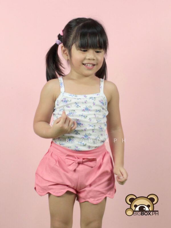 girl in spaghetti tank top and shorts